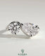 Kynora CJ Toi et Moi engagement ring with 1ct round and 1.5ct pear-shaped diamonds on a wave band.