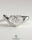 East-West 2ct oval diamond solitaire engagement ring with wave band by Kynora CJ showing the ring's design and sparkling stone.