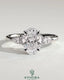 Kynora CJ 2ct oval claw solitaire engagement ring with pear-shaped accents and round shoulder stones, crafted in silver.