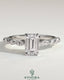 Kynora CJ 2ct emerald claw solitaire engagement ring with marquise and round accent stones, featuring intricate design and sparkling gemstones.