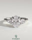 Kynora CJ 2ct oval claw trilogy engagement ring with pear side stones and cathedral setting, showcasing sparkling diamond details.