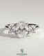Kynora CJ 2ct oval claw trilogy engagement ring with round side stones, open trellis gallery, tapered band, three stone design