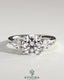 Kynora CJ 2ct round claw trilogy engagement ring with pear side stones and open trellis gallery design.