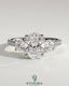 Kynora CJ 2ct oval claw trilogy engagement ring with round side stones, pave band, and trellis gallery design.
