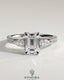 Kynora CJ 2ct emerald claw trilogy engagement ring with pear side stones and pave band, showcasing sparkling fine jewelry.
