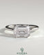 Kynora CJ 2ct emerald cut east-west bezel solitaire engagement ring with a sleek band and prominent gemstone display.