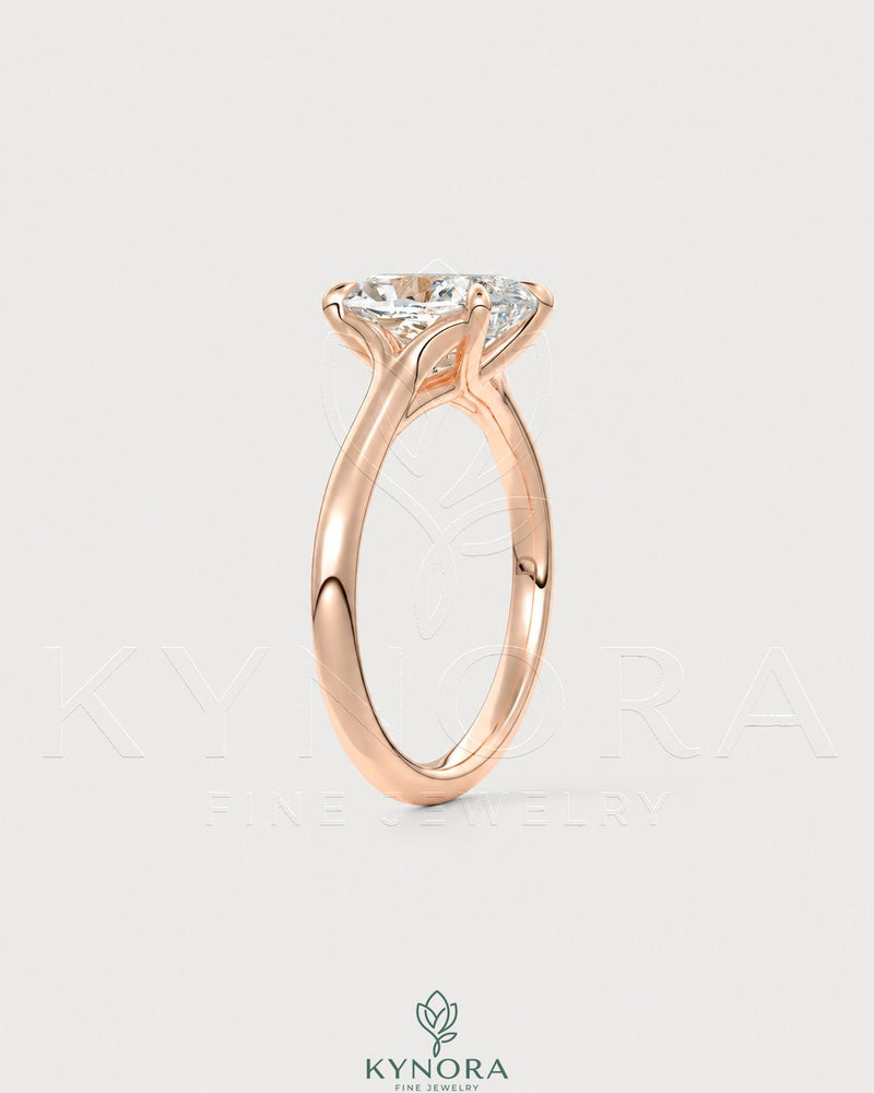 Sterling silver solitaire engagement ring with a cushion cut moissanite gemstone, featuring a sleek and elegant design.