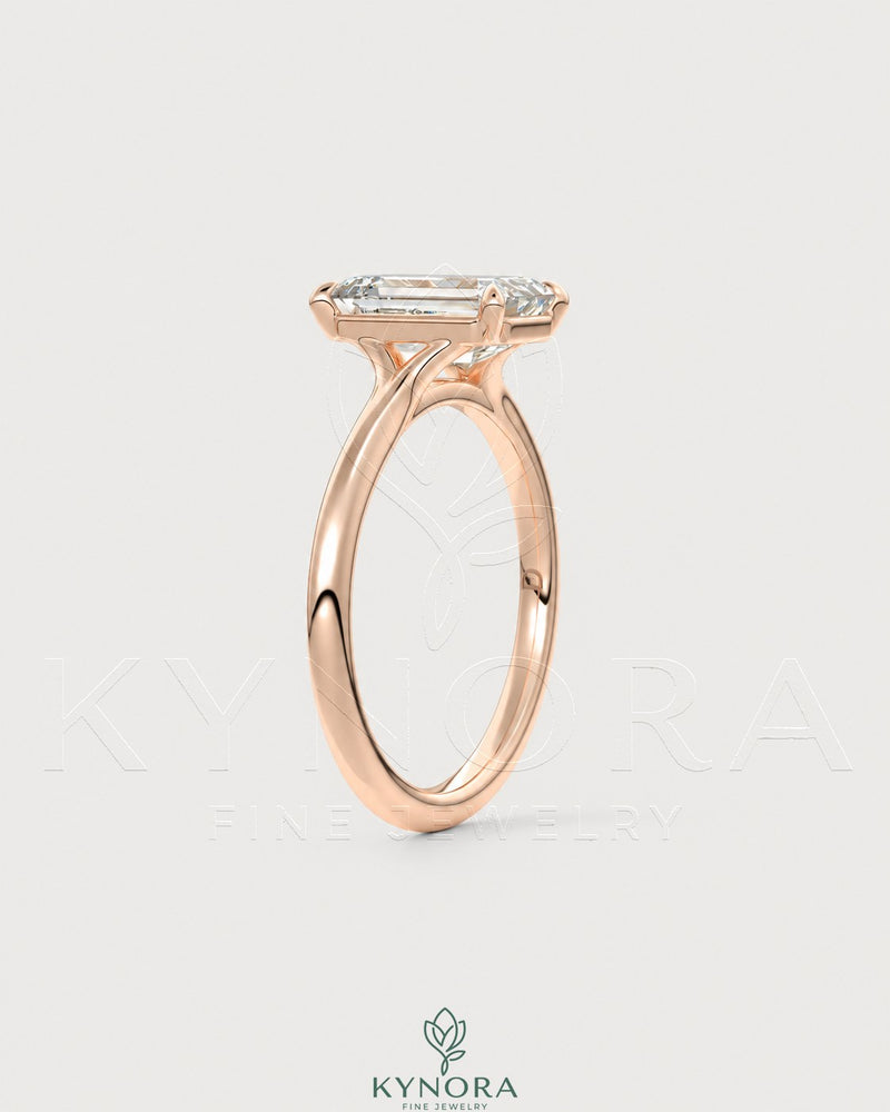 Emerald cut moissanite solitaire engagement ring in 925 sterling silver with a sleek, modern design by Kynora CJ.