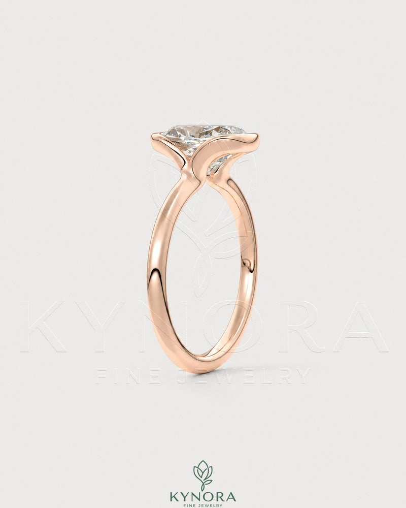 Elongated moissanite half-bezel solitaire ring in 925 silver with a sleek design, by Kynora CJ, displayed on a white background.