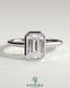 Kynora CJ 2ct emerald bezel solitaire engagement ring with cathedral high setting showcasing a vibrant green emerald gemstone.