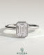 Kynora CJ 2ct emerald bezel solitaire engagement ring with hidden halo and cathedral high setting, showcasing intricate jewelry design.