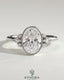 Kynora CJ 2ct oval bezel solitaire engagement ring with marquise and round shoulder stones in a cathedral high setting.