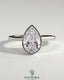 Kynora CJ 2ct pear-shaped bezel solitaire engagement ring with hidden halo and cathedral high setting, showcasing elegant diamond design.