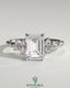 Kynora CJ 2ct emerald claw solitaire engagement ring with round cluster shoulder stones, showcasing elegant design and sparkling gemstones.