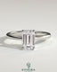 Kynora CJ 2ct emerald claw solitaire engagement ring with tapered band and cathedral low setting, featuring a sparkling emerald gemstone.
