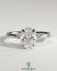 Kynora CJ 2ct oval claw solitaire engagement ring with six accent stones and hidden halo, showcasing sparkling diamond details.