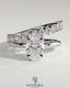 Kynora CJ 2-carat oval claw solitaire engagement ring with double plain and round accent stones band, crafted in elegant jewelry style.