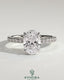 Kynora CJ 2ct oval claw solitaire engagement ring with wrap-around hidden halo and pavƩ band, showcasing elegant diamond setting.