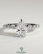 Kynora CJ 2ct pear-shaped diamond solitaire engagement ring with marquise and round accent stones on a silver band.