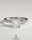 Kynora CJ 2ct princess claw solitaire engagement ring with wrap-around hidden halo and pave band, showcasing sparkling diamond details.