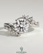 Kynora CJ 2ct round diamond solitaire engagement ring with bypass band and clustered marquise accent stones.