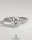 Kynora CJ 2ct round claw solitaire engagement ring with hidden halo and triple pave band, showcasing sparkling diamond details.