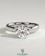 Kynora CJ statement 2ct round diamond claw solitaire engagement ring with cigar band and hidden halo, showcasing elegant jewelry craftsmanship.