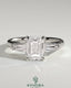 Kynora CJ 2ct emerald claw trilogy engagement ring with tapered baguette side stones and cathedral setting, detailed close-up image.
