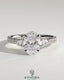 Kynora CJ 2ct oval claw trilogy engagement ring with pear side stones and pave band, showcasing sparkling diamond accents.
