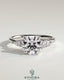 Kynora CJ 2ct round claw solitaire engagement ring with pear-shaped accents and round shoulder stones, three stone design.