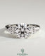 Kynora CJ three-stone engagement ring featuring a 2-carat round claw trilogy center with pear side stones and a knife edge band.