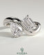 Kynora CJ Claw Toi et Moi engagement ring with wave band featuring two gemstones and intricate band design.