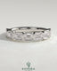 East West Emerald Bezel Set Wedding Ring by Kynora CJ, featuring a central emerald gemstone in a sleek band design.