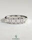 Emerald bezel set wedding ring by Kynora CJ with a sleek gold band and a central green emerald gemstone.