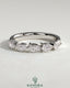 Kynora CJ Pear East West Accent Stone wedding band with closed basket setting, showcasing sparkling gemstones in a elegant gold ring.