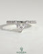 Pear-shaped accent stone with curved pave band wedding ring by Kynora CJ, featuring elegant design and sparkling details.
