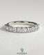Kynora CJ round eternity wedding band in polished metal with continuous gemstone setting, elegant and timeless jewelry piece