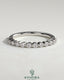 Round shared prong accent stone wedding ring by Kynora CJ, featuring a sleek band with sparkling accent stones.