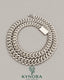 Sterling silver 10mm VVS moissanite Cuban link chain by Kynora Jewels, showcasing its shiny, chunky hip-hop chain style.
