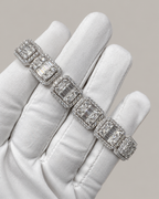 Sterling silver tennis bracelet with baguette links, worn on a white glove, by Kynora Jewels, showcasing elegant hip-hop jewelry style.