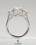 Kynora CJ 2ct round claw trilogy engagement ring with side stones and trellis gallery design, showcasing sparkling diamonds.