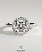 Kynora CJ 2ct round claw solitaire engagement ring with halo and cathedral high setting, showcasing sparkling diamond design.