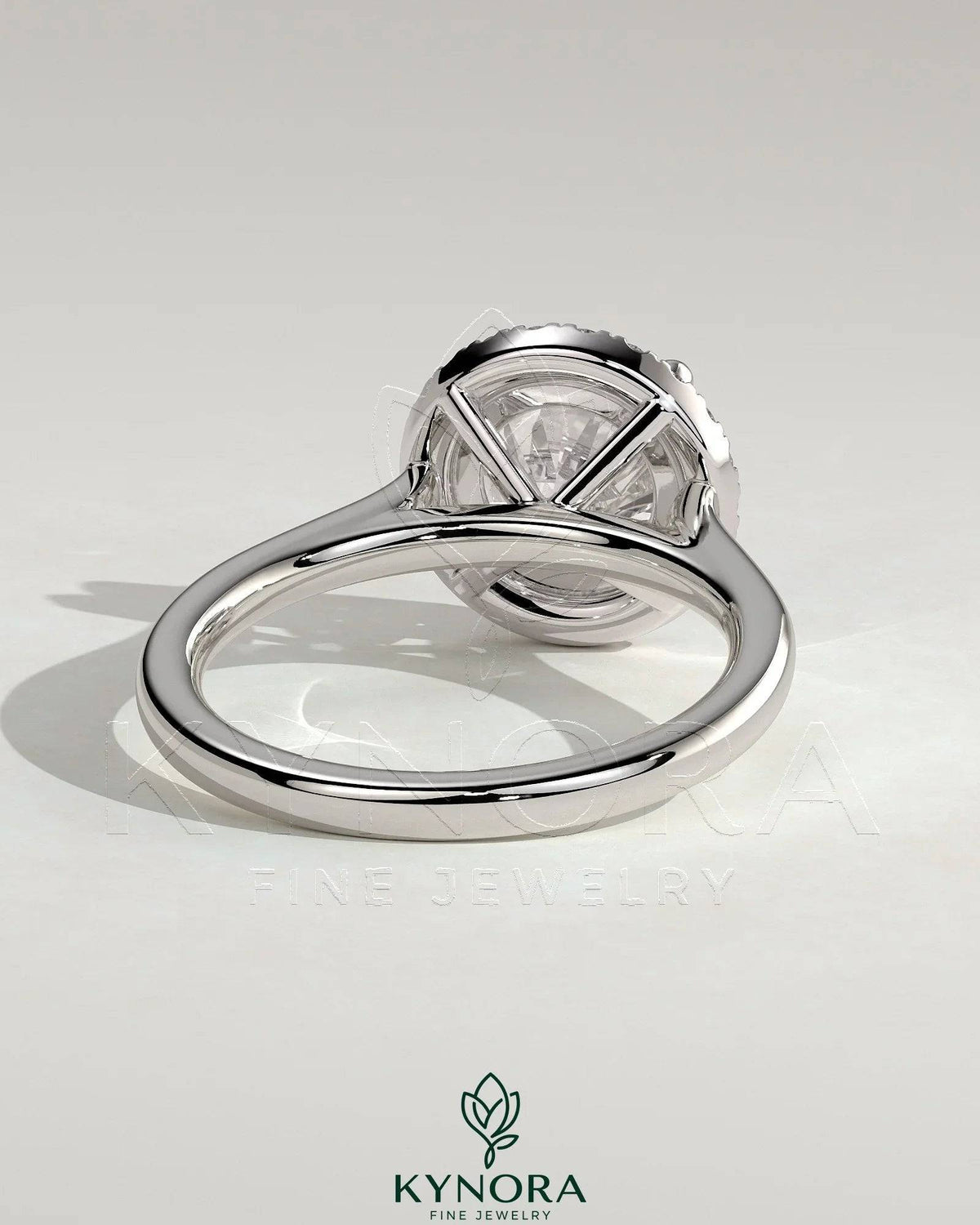 Kynora CJ 2ct round claw solitaire engagement ring with halo and cathedral high setting, showcasing sparkling diamond design.