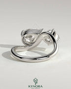 Kynora CJ Toi et Moi engagement ring with 1ct round and 1.5ct pear-shaped diamonds on a wave band.