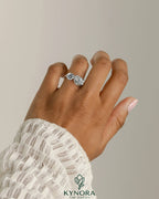 Kynora CJ Toi et Moi engagement ring with 1ct round and 1.5ct pear-shaped diamonds on a wave band.