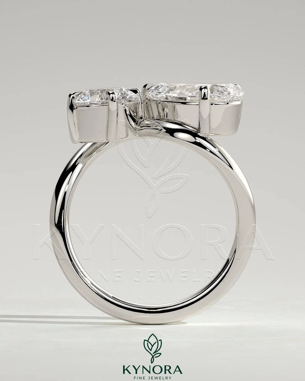 Kynora CJ Toi et Moi engagement ring with 1ct round and 1.5ct pear-shaped diamonds in a wave band setting.