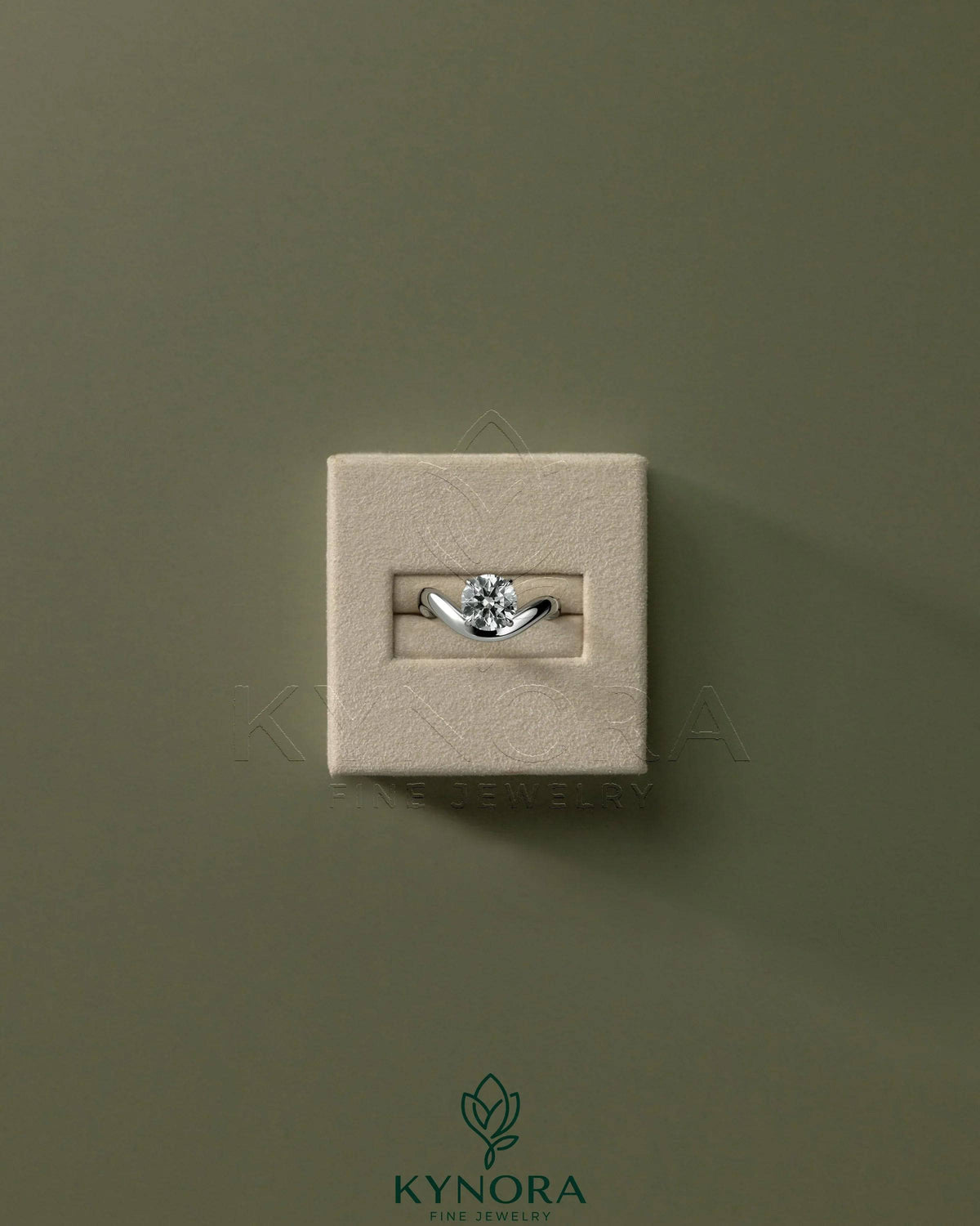 Kynora CJ 2ct round east-west claw solitaire engagement ring with wave band, showcasing a sparkling central diamond and elegant design.