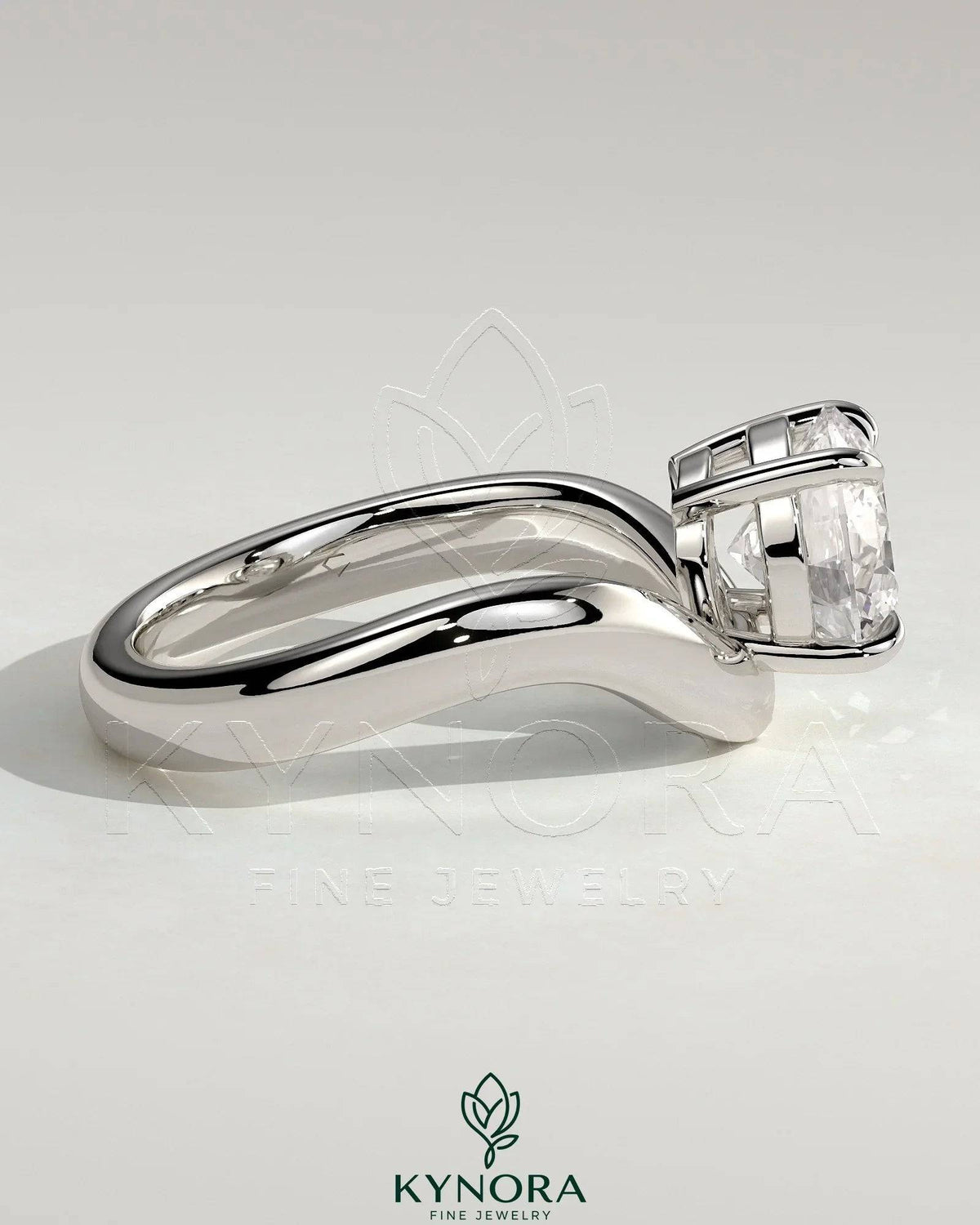 Kynora CJ 2ct round East-West claw solitaire engagement ring with wave band, showcasing a sparkling diamond and unique design.