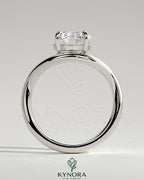 Kynora CJ 2ct round east-west claw solitaire engagement ring with wave band, showcasing a sparkling diamond and elegant design.