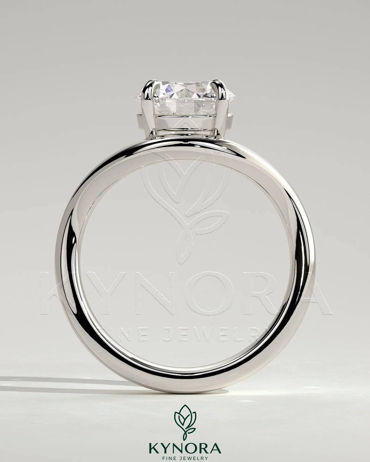Kynora CJ 2ct round east-west claw solitaire engagement ring with wave band, showcasing a sparkling diamond and elegant design.